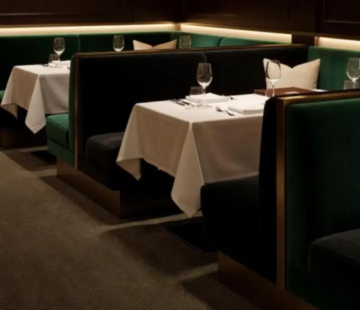 Emerald club lounge interior with velvet seating and intimate tables at The Fork bistro.